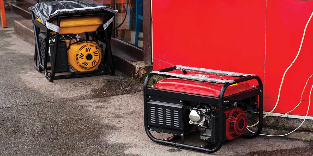 Two portable generators placed outside a building, providing emergency power for essential appliances. This image showcases compact generators that are easy to set up and ideal for powering lights, fans, and small electronics. If you're choosing the right generator for emergencies, these portable options are practical and versatile. Expert Electric can guide you in selecting the perfect portable generator.