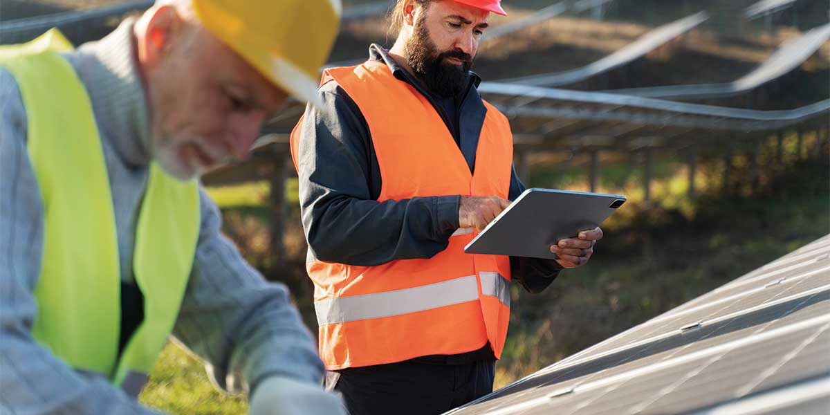 Engineers reviewing a solar panel system installation. Expert Electric specializes in solar energy solutions, proving solar power facts and busting common misconceptions about renewable energy.