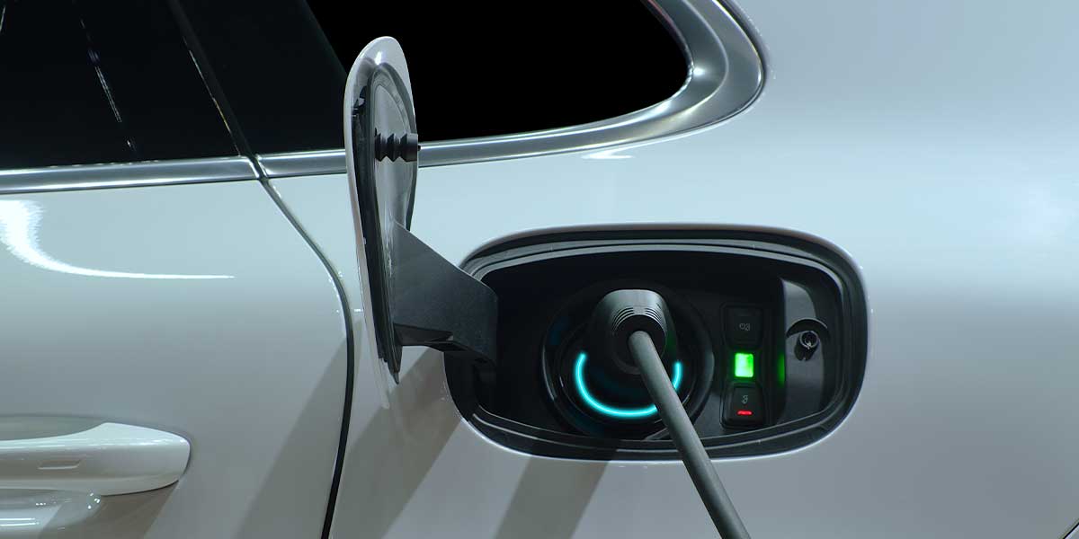 Electric Vehicle Myths Debunked Close-up of an electric vehicle charging port in use, visually supporting Electric Vehicle Myths Debunked by highlighting the simplicity and accessibility of modern EV charging systems for all users.