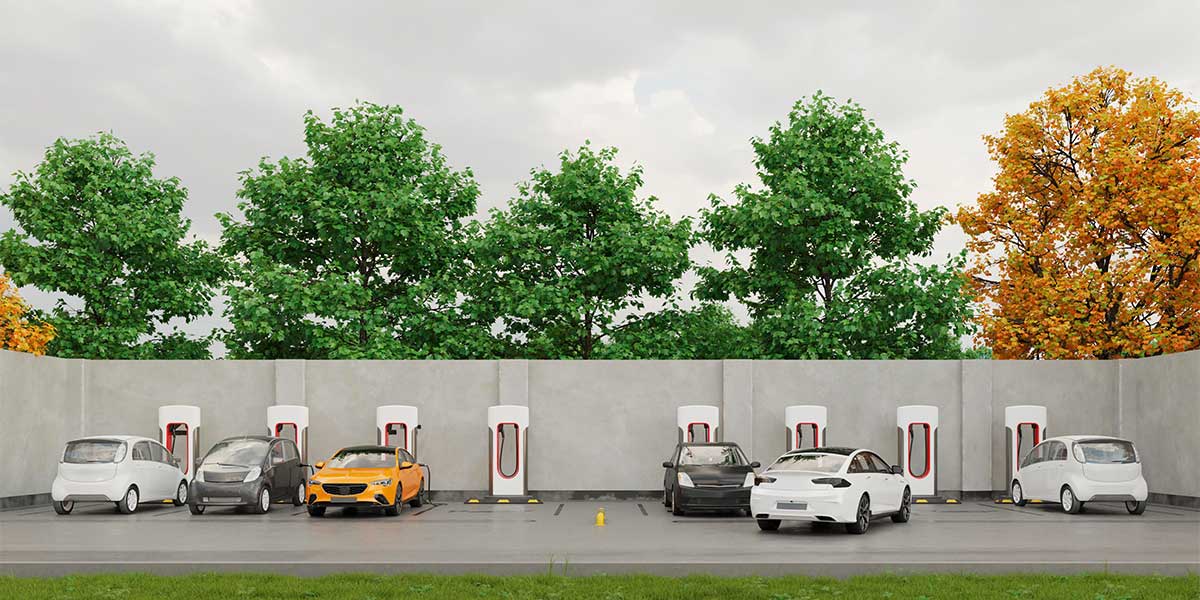 A row of electric vehicles charging at a fast-charging station, illustrating the truth behind Electric Vehicle Myths Debunked by showing widespread public infrastructure supporting long-distance travel and daily use.