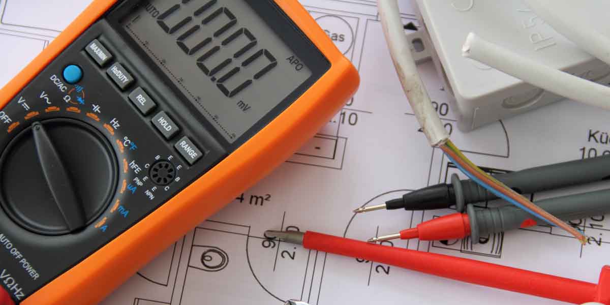 Close up of electrical tools on a building plan schematic.