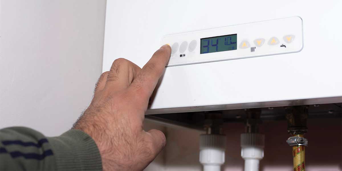 Heating system got you down? This close-up image highlights a user adjusting the digital thermostat of a modern boiler system, ensuring optimal home comfort. Expert Electric specializes in addressing heating system concerns, offering professional repair and maintenance services to keep your system running smoothly. Trust Expert Electric for all your heating system needs in Vancouver and the Lower Mainland.