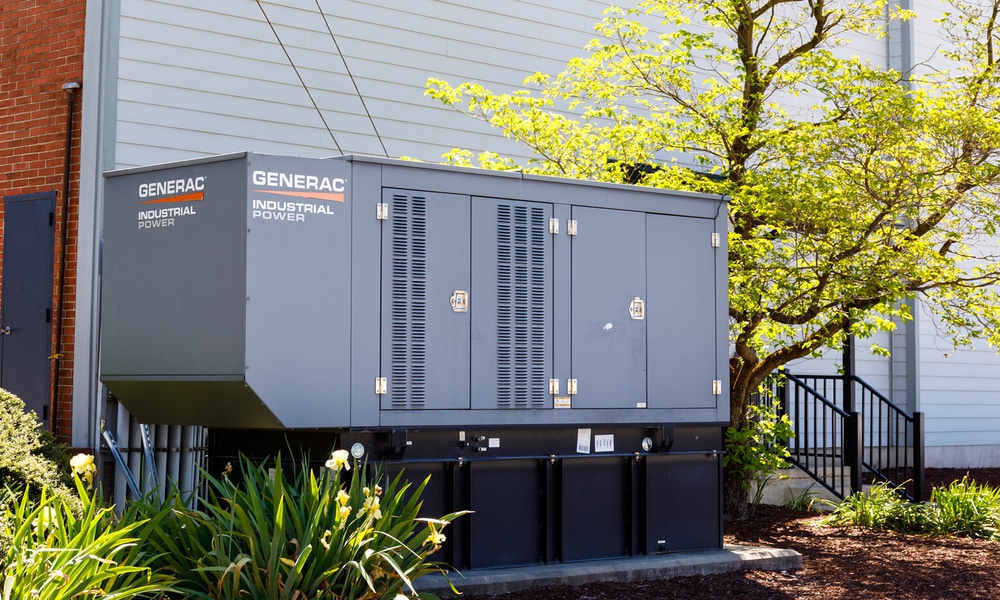 Generac industrial standby generator installed beside a building—showcasing one of the best generator brands for reliable power in BC winters.