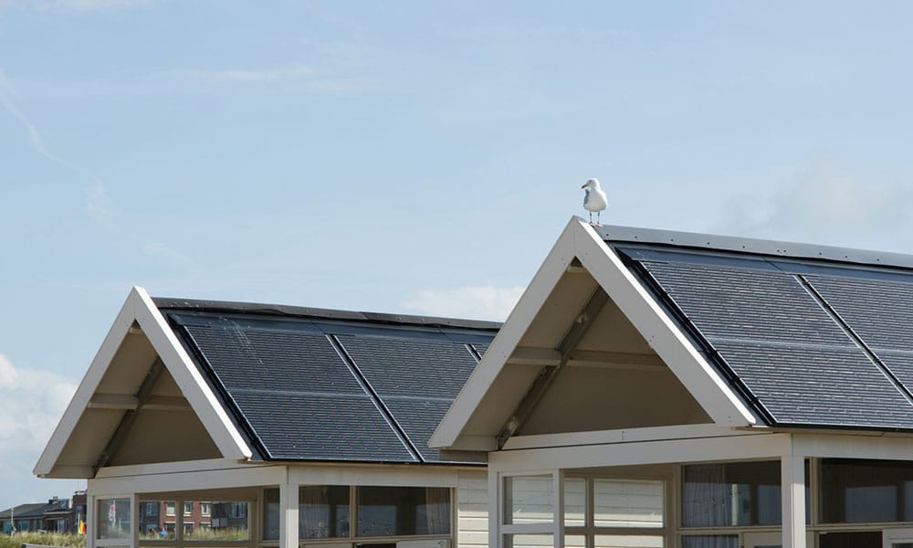 Rooftop solar panels capturing sunlight to generate clean solar energy for home backup power.