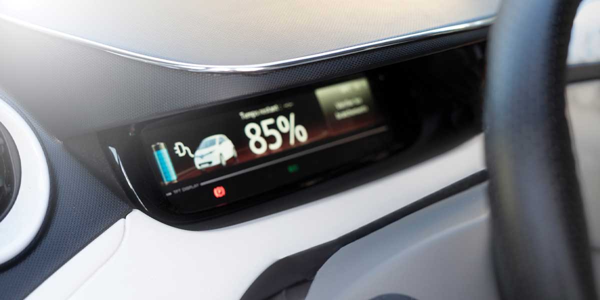 A car dashboard showing an 85% charge level, illustrating advancements in battery technology during the Evolution of Electric Vehicles.