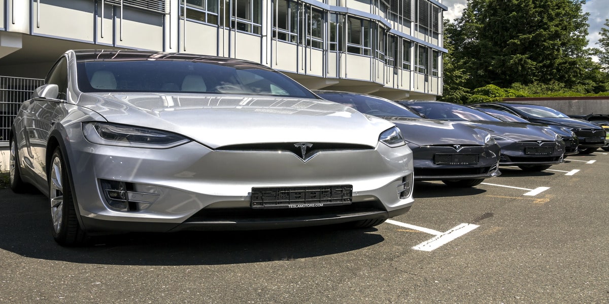 Expert Electric explores Comparing Top EV Models in 2025: What’s New and Noteworthy? with Teslas lined up to highlight cutting-edge electric tech.