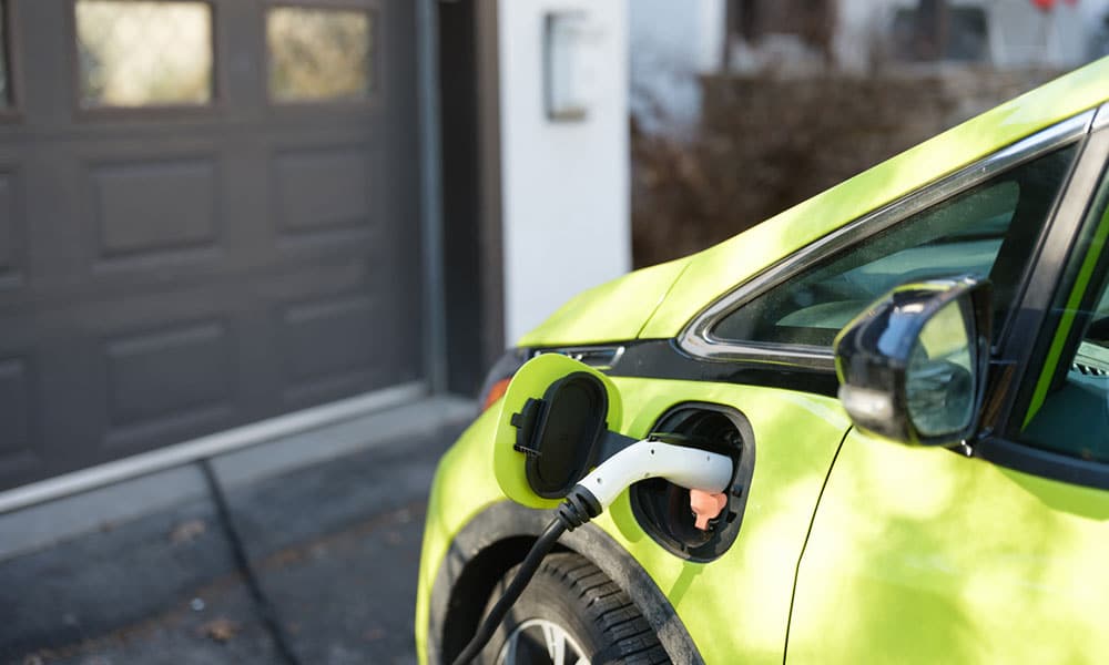 Professional electrician performing EV charger installations in a residential garage