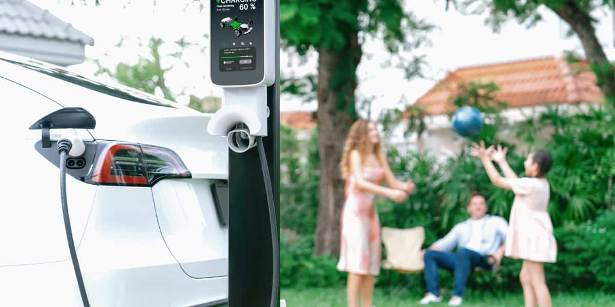 Understanding EV Charging Stations: Types, Locations, and Costs shown with a home EV charging station by Expert Electric in a family-friendly backyard setting.